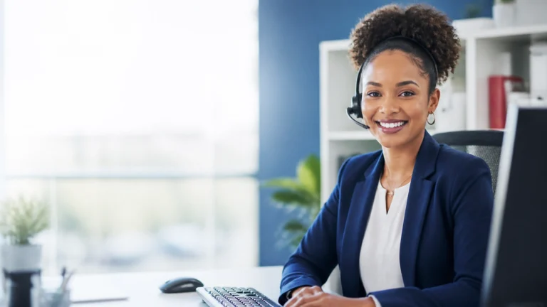 Live answering service representative providing professional phone support at a modern workstation