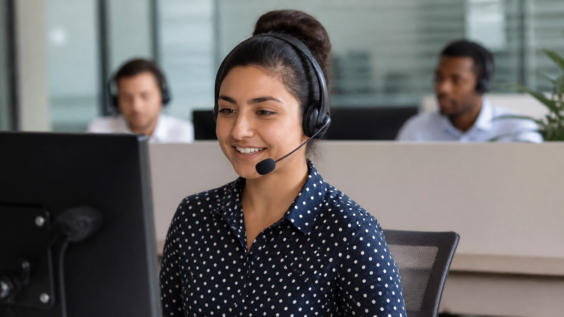 Call center services team member managing customer inquiries in a professional office